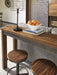 Torjin - Dark Brown - 3 Pc. - Long Counter Table, 2 Stools Sacramento Furniture Store Furniture store in Sacramento